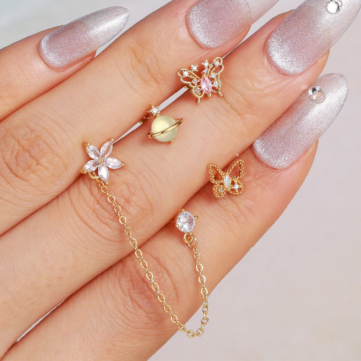 piercing dorado de flor, piercing doble, piercing de flor con piedra, piercing largo