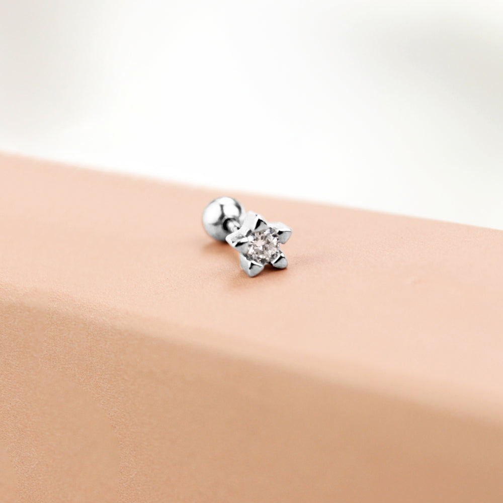 Piercing en forma de estrella plateada con piedra al centro 